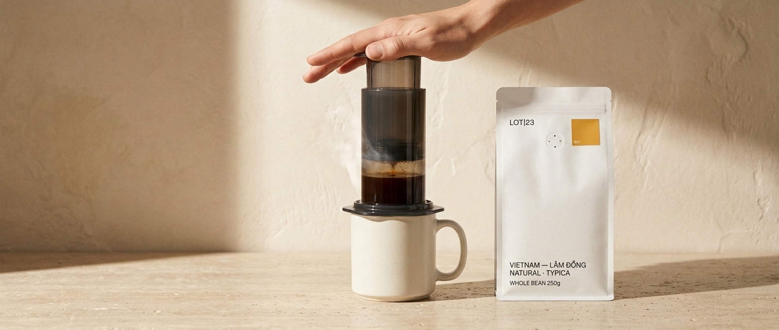 AeroPress being pressed down over a cup